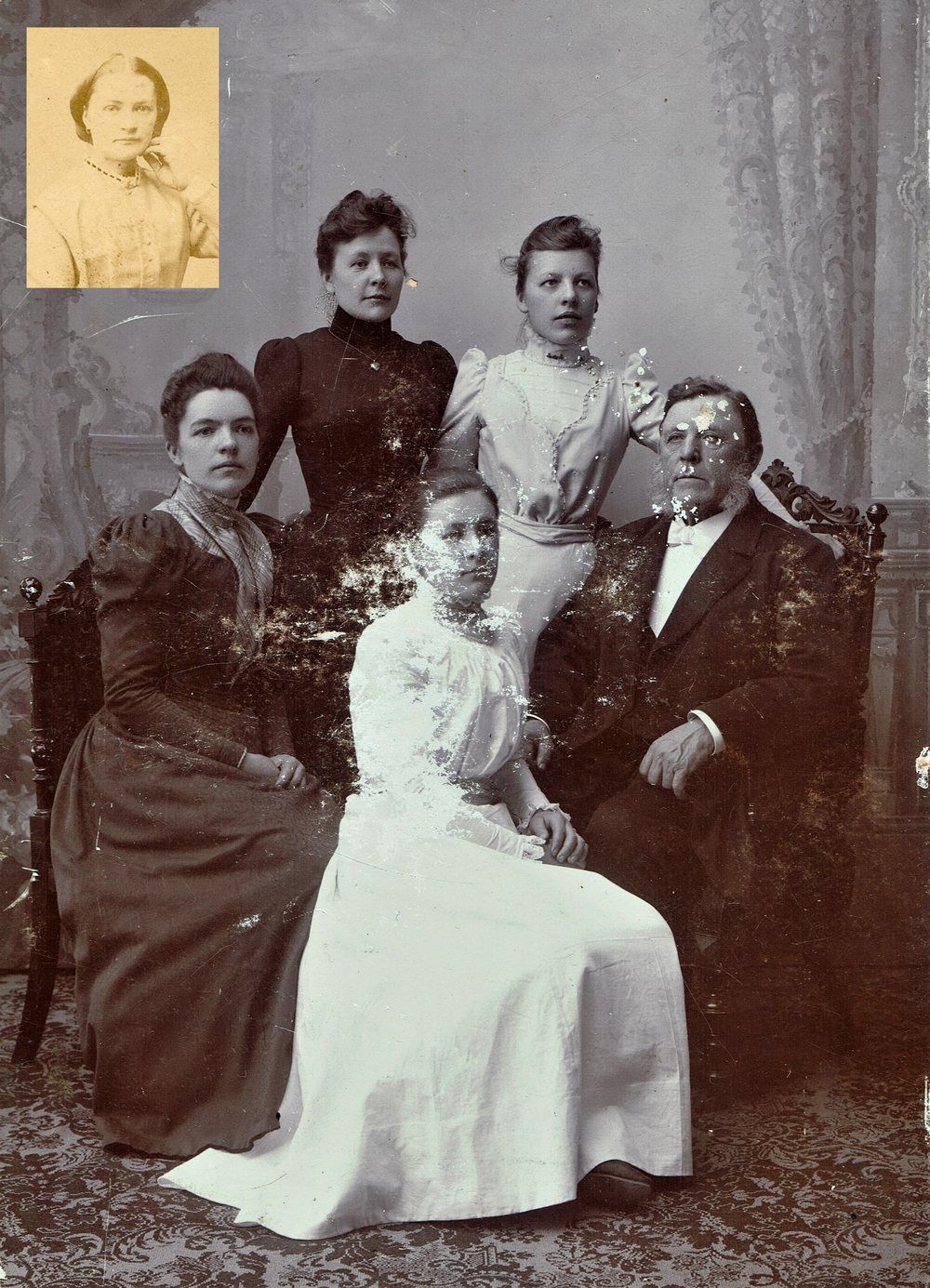 The original c.1907 family portrait, brown and spotted, with white flaking across the woman seated in front